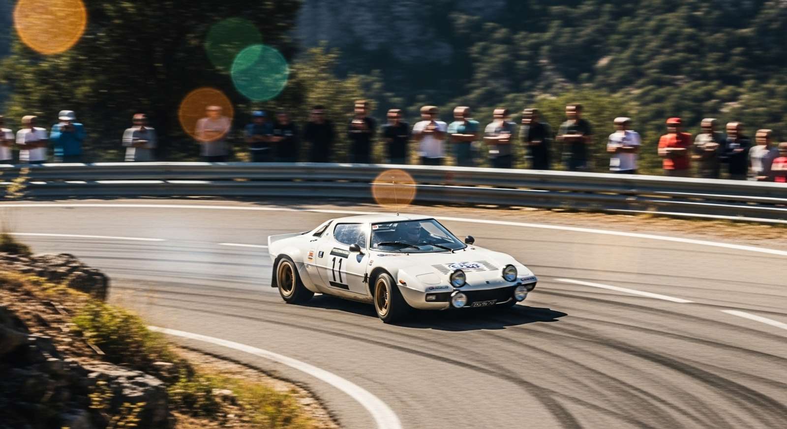 A dynamic action shot of a classic 1970s rally car, Lancia Stratos, drifting around a tight hairpin bend on a mountain road in the South of France. 