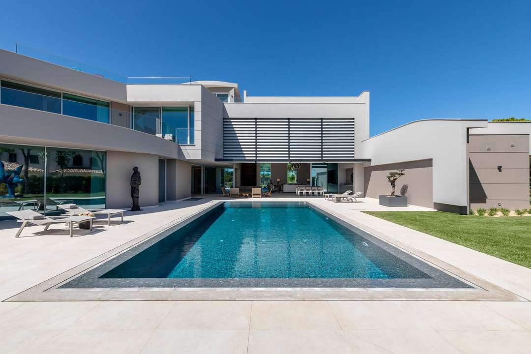 Luxury villa in Quinta do Lago featuring a 13-meter heated private pool, modern architecture, and elegant outdoor lounging.