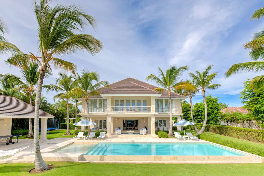 Arrecife 39 luxury villa exterior with a pristine private pool, sun loungers, and tropical gardens in Punta Cana.