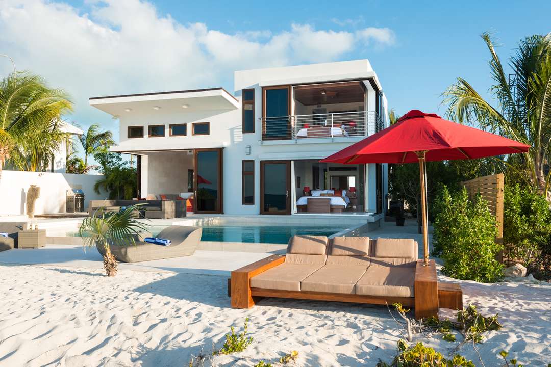 Contemporary beachfront villa Beach Kandi featuring a private pool, limestone terrace, and seamless indoor-outdoor living.