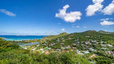 Breathtaking panoramic views of St-Jean Bay, showcasing the azure ocean, lush verdant hills, and iconic island landscape.