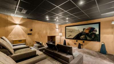 State-of-the-art private home cinema featuring a large screen and comfortable tiered seating at Golden Carolina villa.