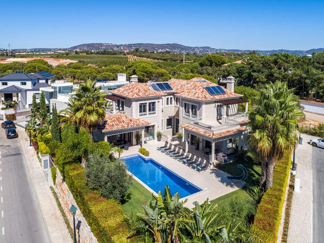 Aerial view of Casa 19 in Quinta do Lago, featuring traditional architecture, a private pool, and sweeping country views.