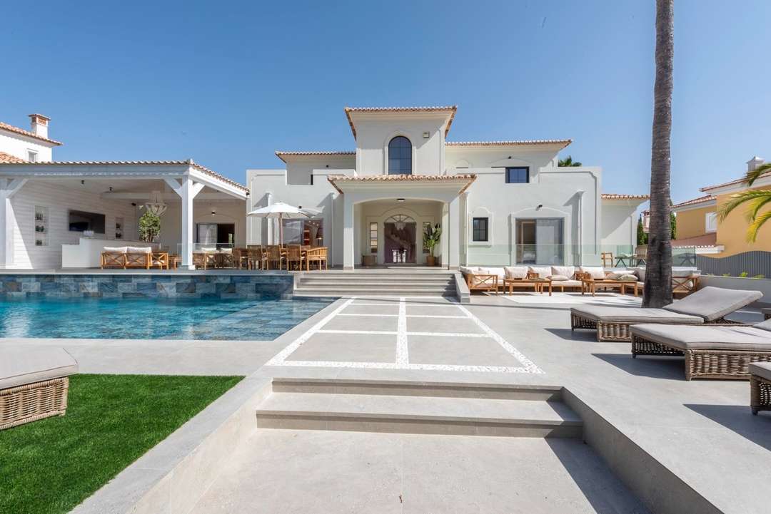 Luxury Quinta do Lago villa exterior featuring a private pool, sun loungers, and elegant outdoor living spaces.