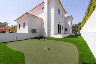 Private three-hole putting green set within the landscaped gardens of a luxury holiday villa in Quinta do Lago.