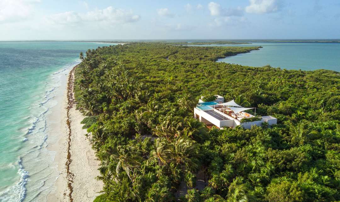 Aerial view of Casa Ikal, a luxury beachfront villa nestled between the Caribbean Sea and lush Sian Ka'an nature reserve.