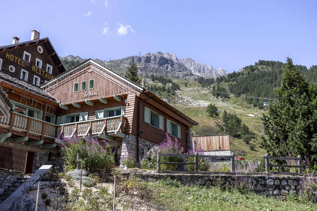 Exterior of luxury Chalet Névé in Val d'Isère featuring a traditional wooden facade and stunning mountain views.
