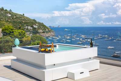Relax in the rooftop jacuzzi at Villa Costalieta, offering panoramic turquoise sea views and an elegant coastal experience.