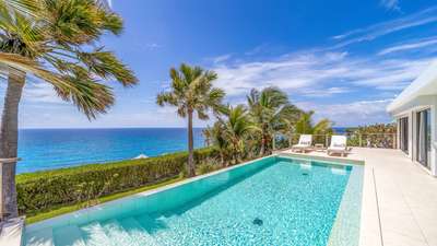 Expansive outdoor terrace and infinity pool at Villa Enzuma, offering elegant lounging and panoramic St-Barths sea views.