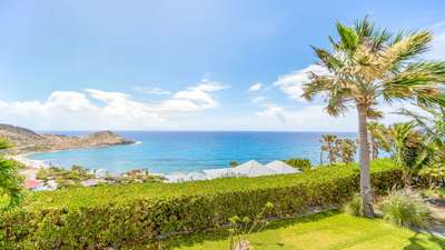Breathtaking panoramic views of the Caribbean Sea and wild eastern coastline from the lush tropical gardens of Villa Enzuma.