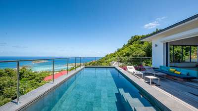Heated private pool and wooden terrace at Villa Feyrouz, offering breathtaking ocean and lagoon views in Vitet, St-Barths.