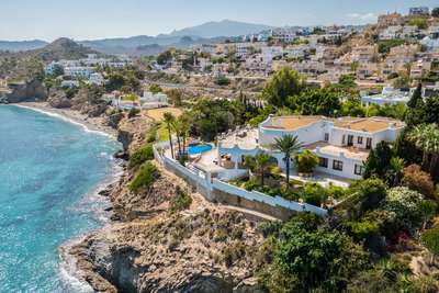 Aerial view of a luxury seafront villa in Villajoyosa featuring expansive terraces, a private pool, and endless sea views.