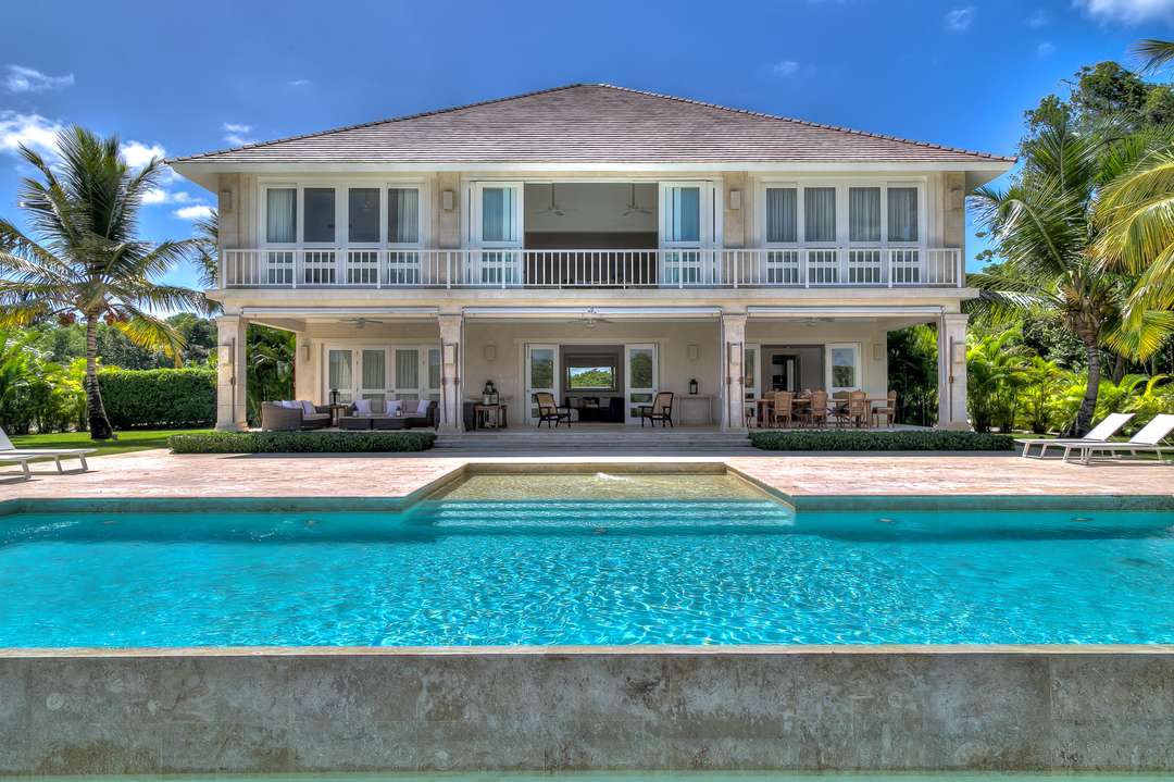 Stunning Hacienda A21 exterior featuring a private pool with elegant stone surround and a spacious two-story villa design.