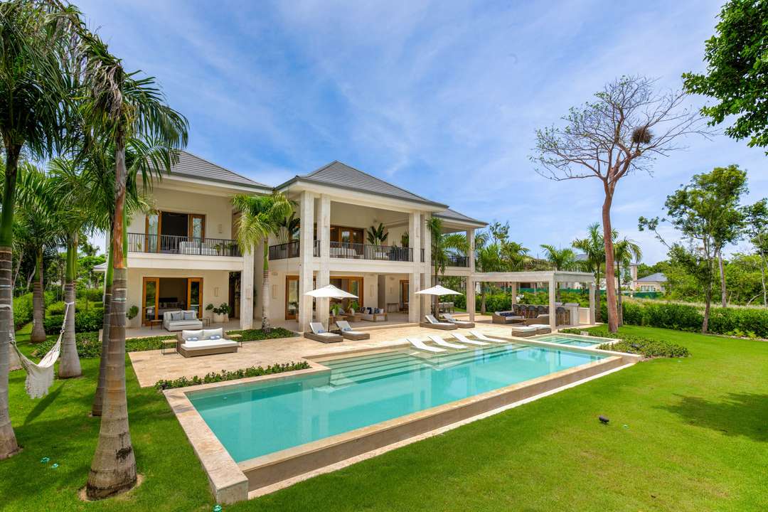 Sleek modern Hacienda A31 in Punta Cana featuring a pristine private pool, sun loungers, and lush tropical garden views.