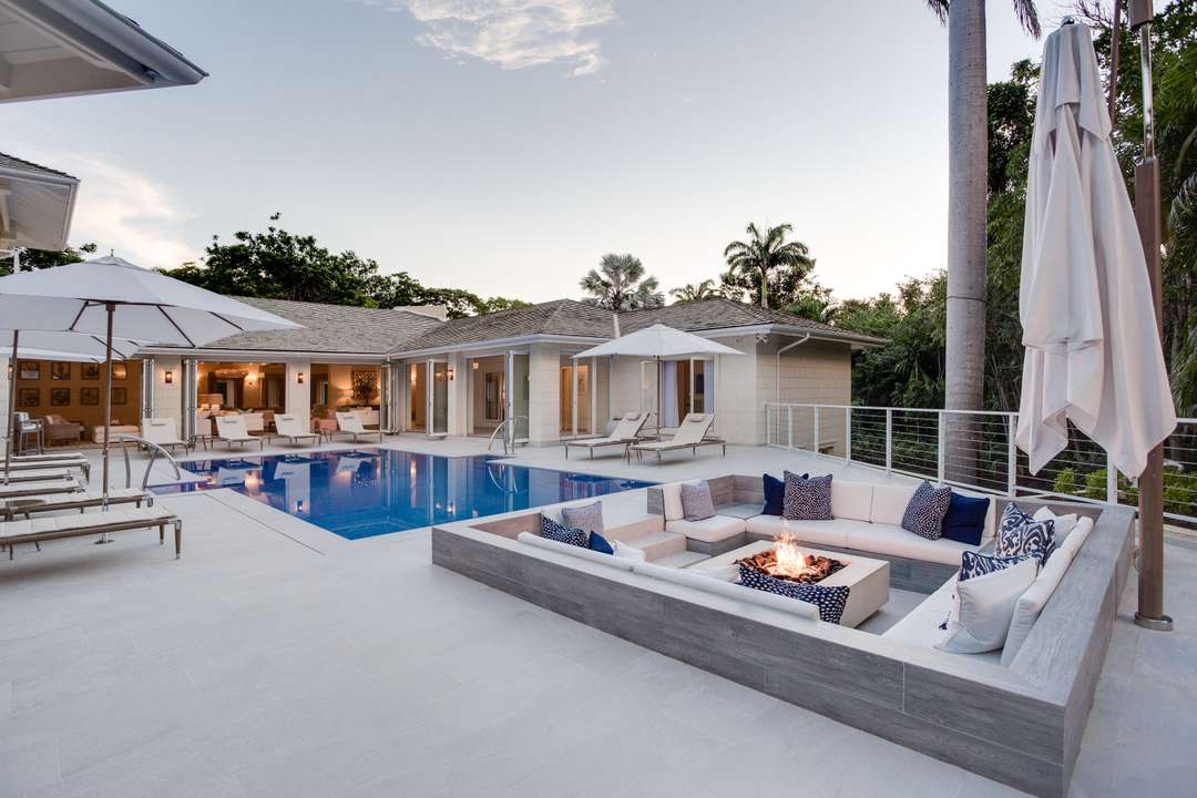 Sunken fire pit lounge with plush seating by the private pool at Villa Horizons, offering elegant outdoor living in Barbados.