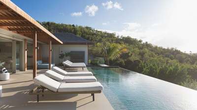 Shaded pergola and sun loungers by the private heated pool at luxury Villa Jnana.