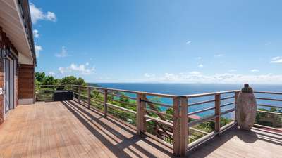 Expansive wooden terrace at Villa Kailio offering panoramic ocean views and elegant outdoor living in Colombier.