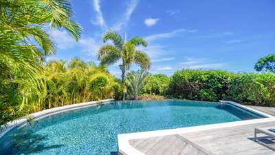 Stunning private pool offering peaceful relaxation, overlooking the lush green rolling hills of Vitet under a blue sky.