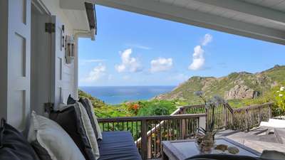Luxurious covered terrace lounge with comfortable seating, perfect for enjoying gentle trade winds and sweeping ocean vistas.