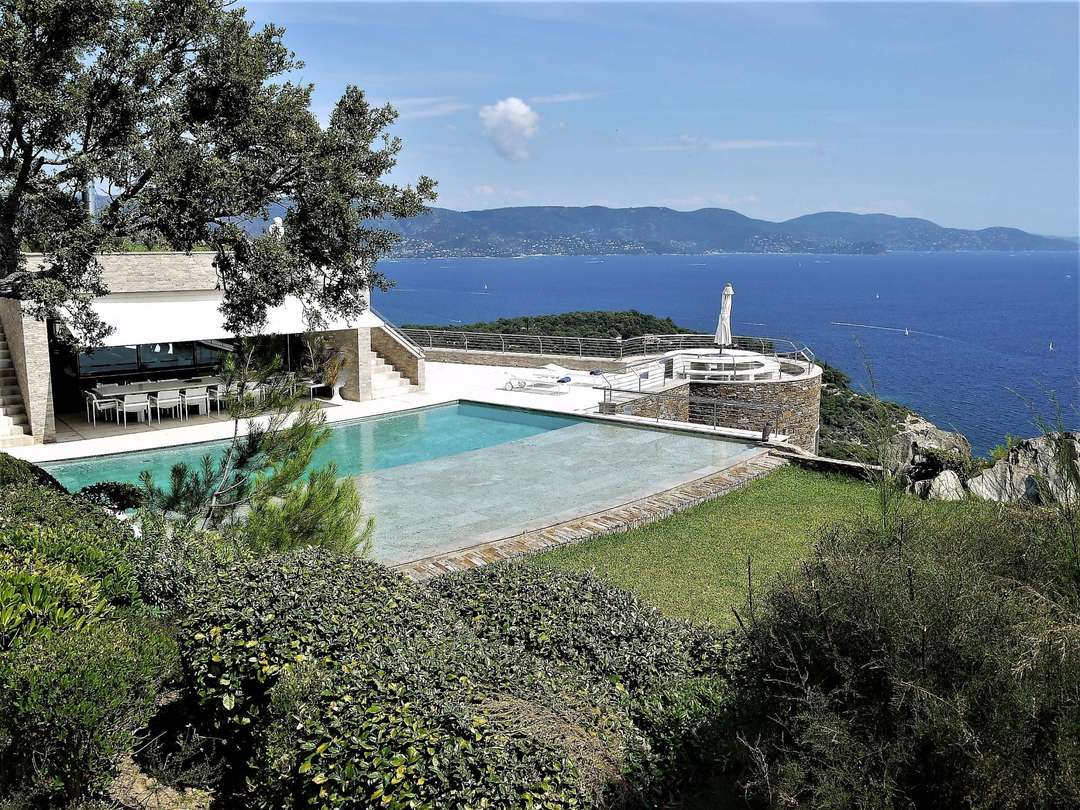 Stunning heated infinity pool and stone terrace overlooking the Mediterranean Sea at luxury La Villa du Cap Benat.