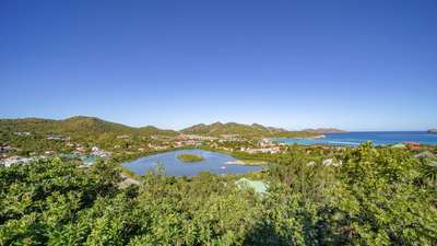 Breathtaking panoramic views of St-Jean bay and shimmering lagoon from the secluded hillside setting of Villa Les Acajous.