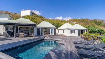 Elegant outdoor living at Villa Mademoiselle, featuring a private pool, teak deck, and seamless access to the living area.