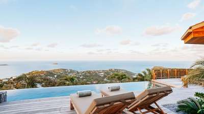 Serene sunset views from the heated infinity pool and wooden deck at Villa Mamiami, an elegant luxury escape in St. Barths.