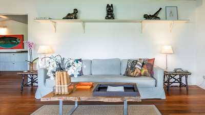 Elegant living area with a live-edge wood coffee table, comfortable seating, and refined ethnic-inspired decor in St. Barths.