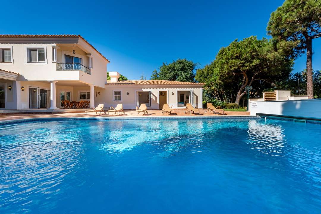Luxury Quinta do Lago villa featuring a 15m heated private pool, terracotta terrace, and elegant sun loungers.