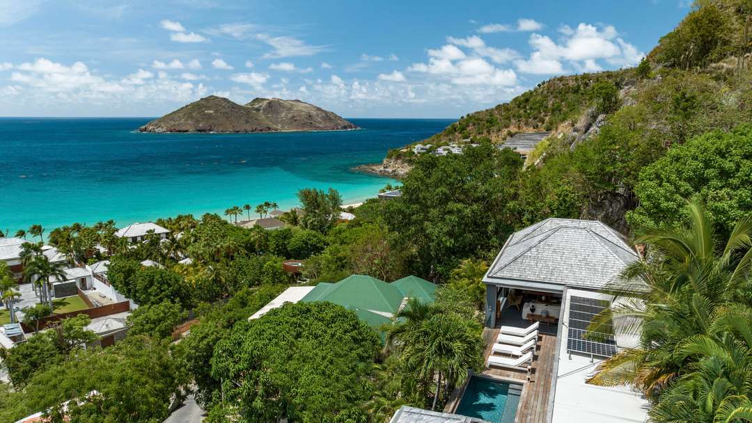 Aerial view of Villa Santa Alicia in St. Barths, showcasing its lush hillside setting and breathtaking turquoise ocean views.
