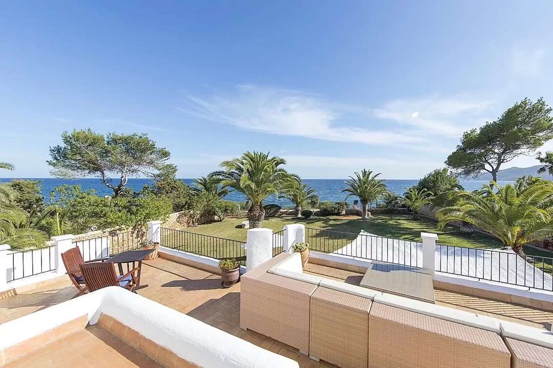 Elegant rooftop terrace at Sea Breeze Estate with rattan seating, overlooking lush tropical gardens and stunning sea views.
