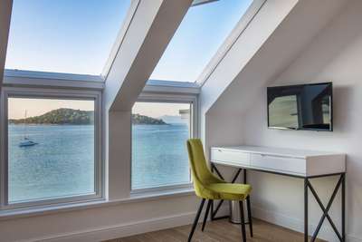 Elegant workspace in a top-floor bedroom at Seaside Bliss Korcula, offering stunning Adriatic Sea views and natural light.