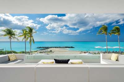 Panoramic ocean views from the sleek terrace of Sole E Mare in Grace Bay, featuring modern outdoor lounge seating.