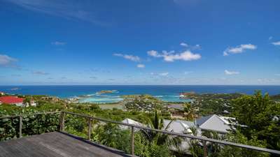 Breathtaking panoramic views of the Caribbean Sea and Grand-Cul-de-Sac from the expansive wooden terrace of Villa Teddy.