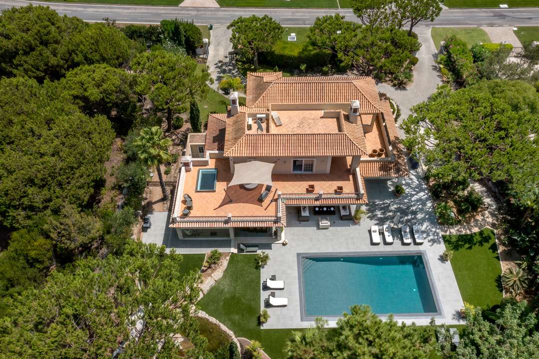 Aerial view of Villa Atlantico featuring a classic terracotta roof, expansive tiled terrace, and a large private pool.