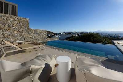 Sunlit terrace with a private pool offering stunning sea and village views at this luxury Cycladic villa in Piso Livadi.
