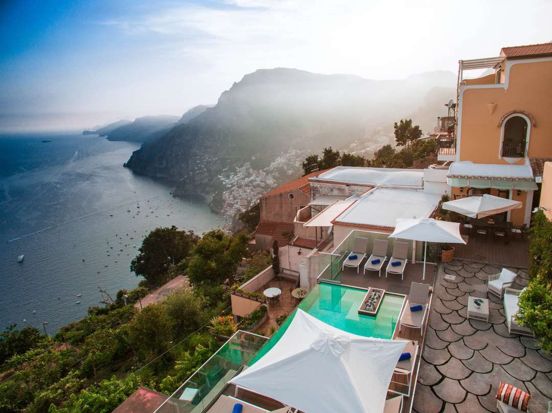 Panoramic terrace at Villa Carmana featuring an infinity plunge pool and breathtaking Amalfi Coast views for luxury travelers.