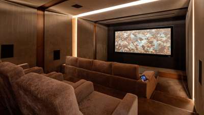 Soundproofed home cinema at Villa Cavado featuring tiered plush seating and a large screen for ultimate entertainment.