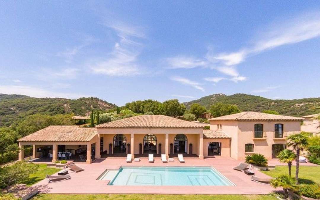 Exterior of Villa du Paradis in Grimaud featuring a private pool, elegant terrace, and panoramic Mediterranean country views.