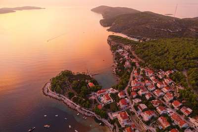 High aerial view of Hvar's coastline at dusk, featuring Villa Sapphire's exclusive beachfront setting and panoramic sea views.