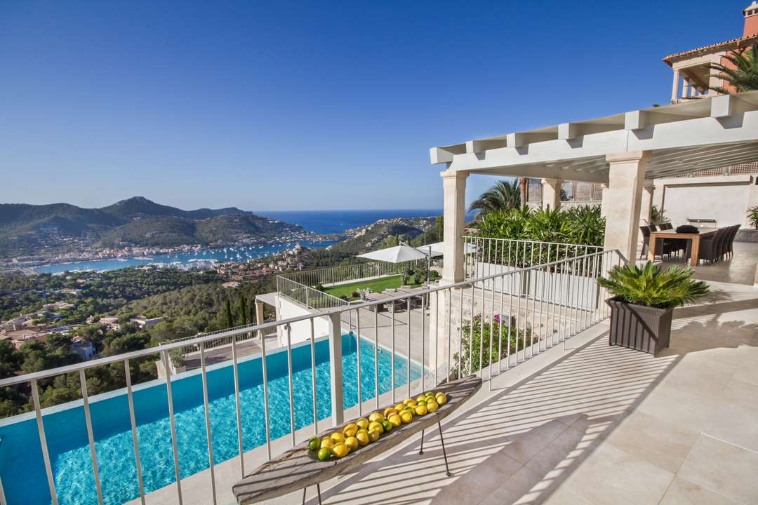 Villa Monport terrace with infinity pool and panoramic views of Port d'Andratx. Luxury outdoor living in Mallorca.
