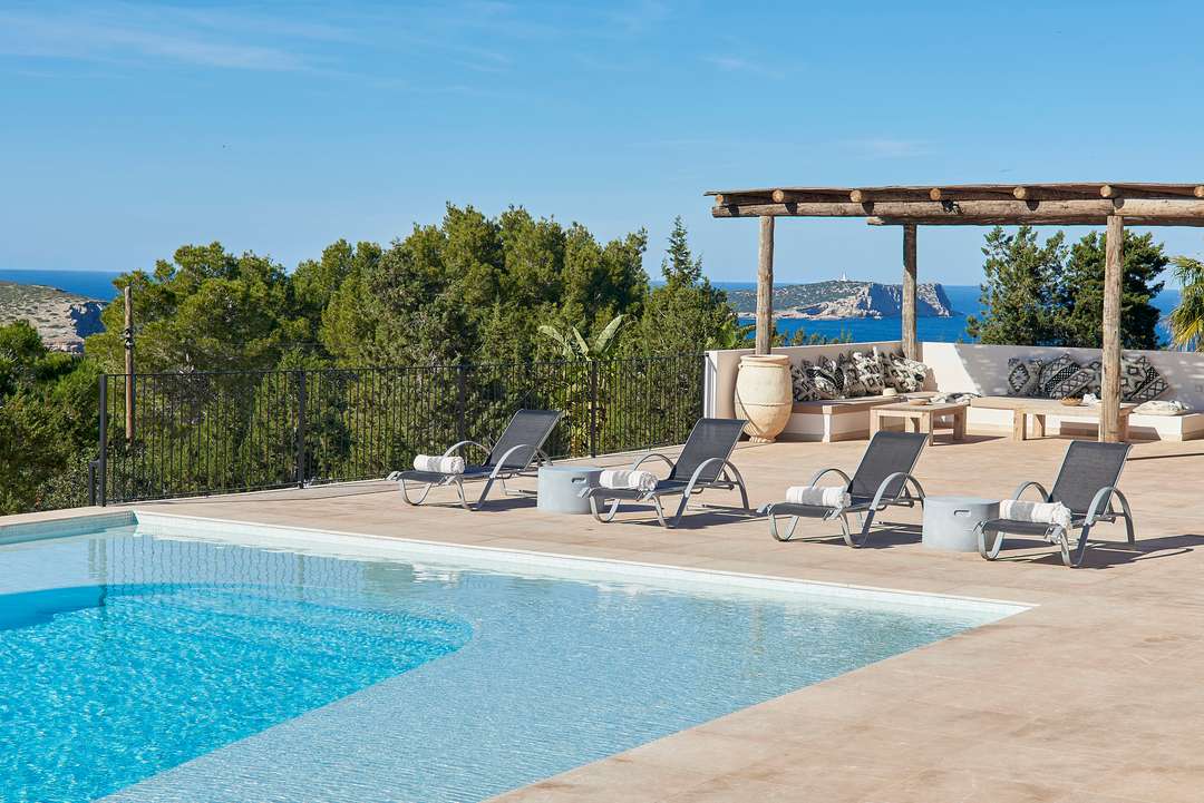 Expansive private pool and sun terrace at luxury Villa Cala Vista, featuring sleek loungers and breathtaking sea views.