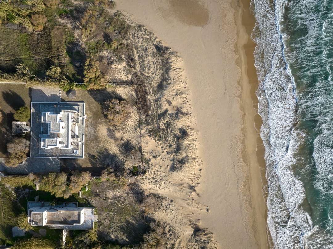 Aerial view of Beach Walk villa on Golden Beach, showcasing its pristine beachfront location and sweeping Aegean Sea views.