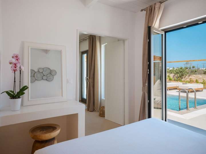Elegant bedroom at Olive & Vines offering seamless access to the heated private pool and sun-drenched outdoor living spaces.
