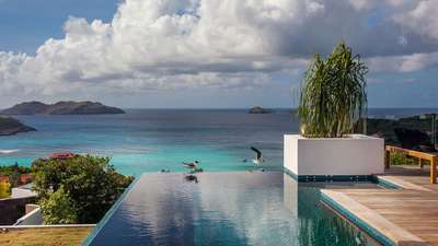 Heated infinity pool at luxury Villa Wings in St. Barths, offering breathtaking panoramic views of the Caribbean Sea.